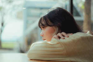 young girl woman looking into distance solemn thinking inquisitive
